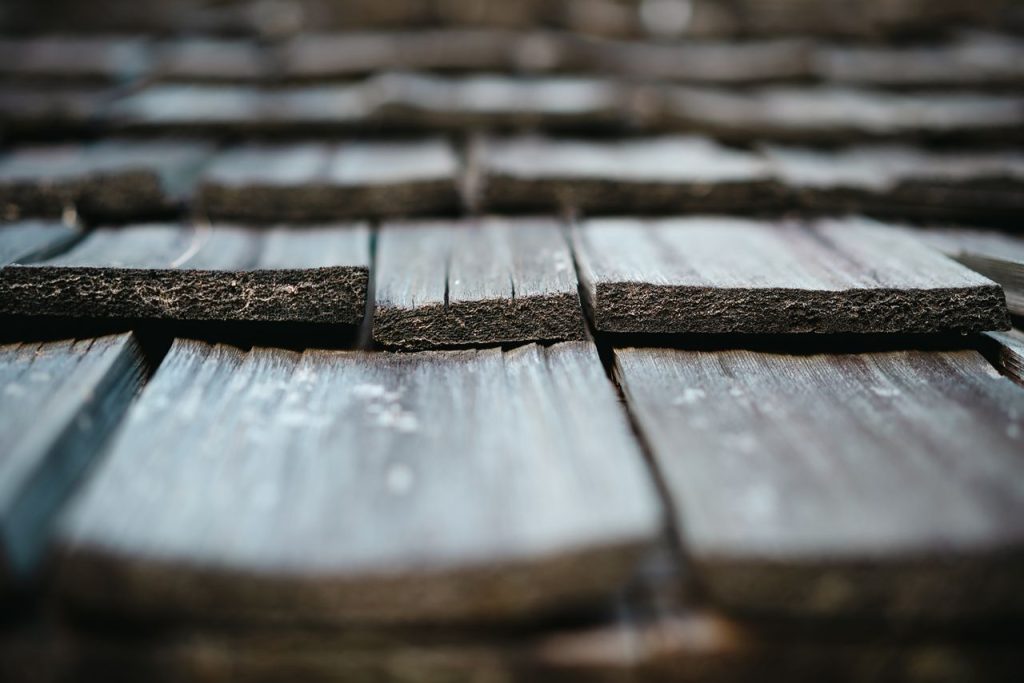 Detailed close-up of rustic weathered wooden shingles, showcasing texture and natural aging.